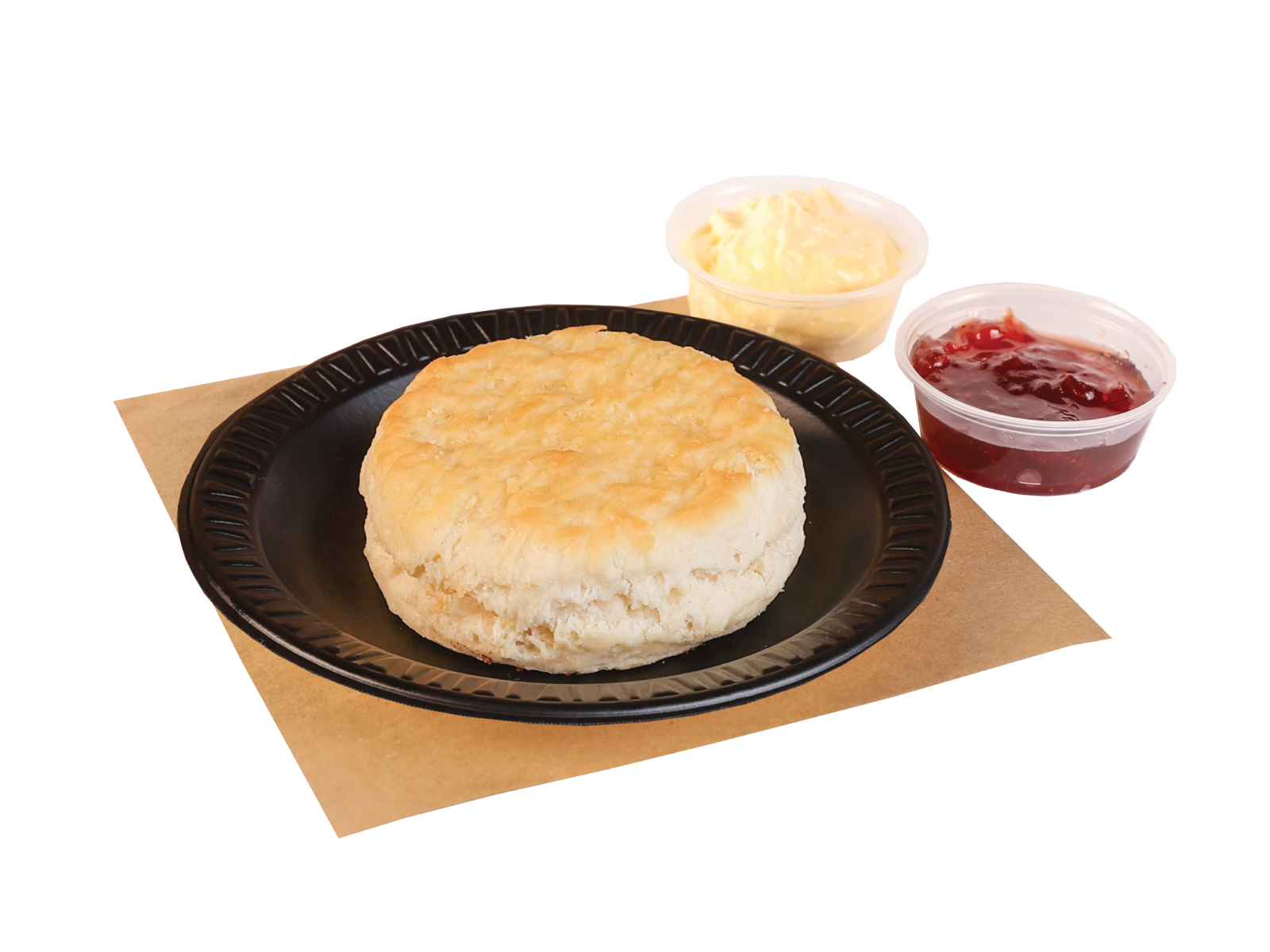 A biscuit on a black plate on butcher paper. Butter and jelly are placed beside the biscuit