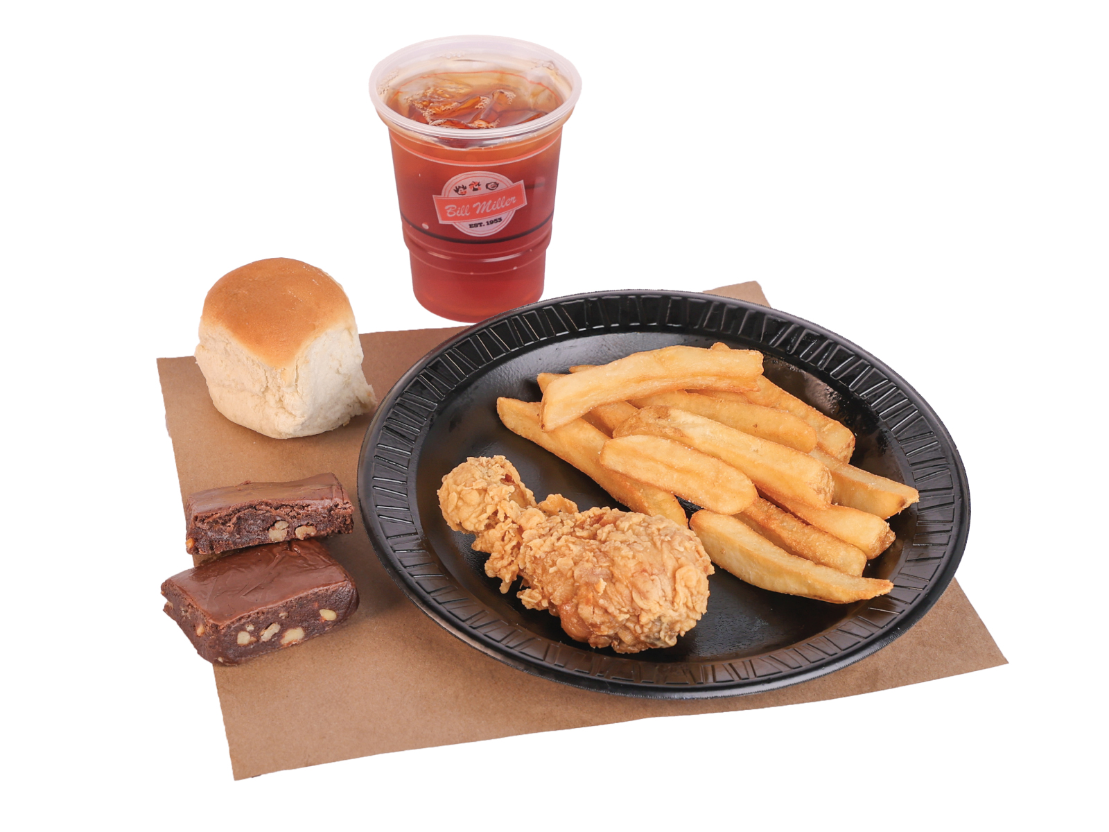 Buckaroo 1 Pc. Chicken Leg served with french fries on a black plate. A small tea, dinner roll, and portion of brownies are placed beside the plate on brown butcher paper.