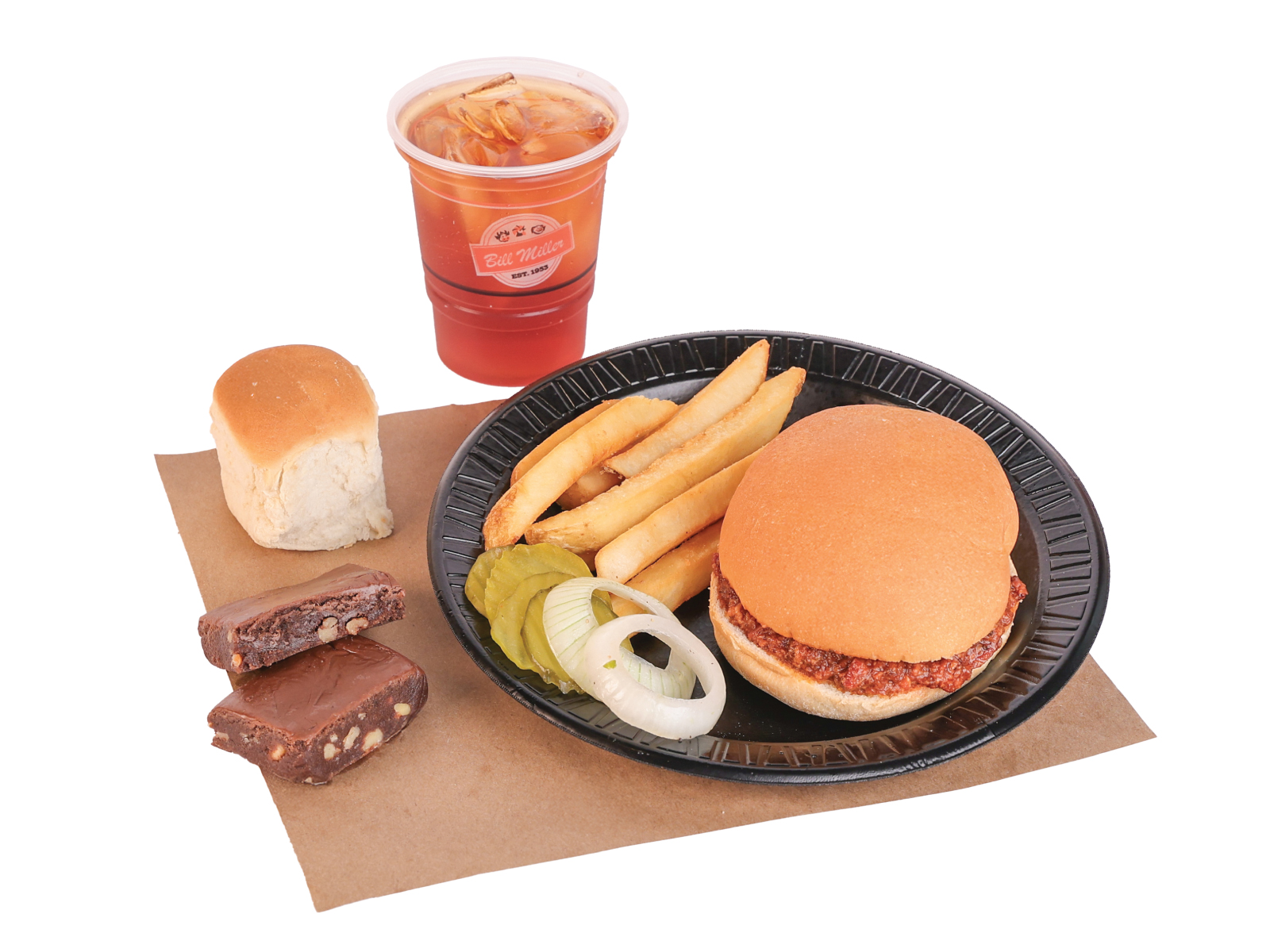 Buckaroo 1 Chopped Sandwich served with french fries, pickles, and onions on a black plate. A small tea, dinner roll, and portion of brownies are placed beside the plate on brown butcher paper.