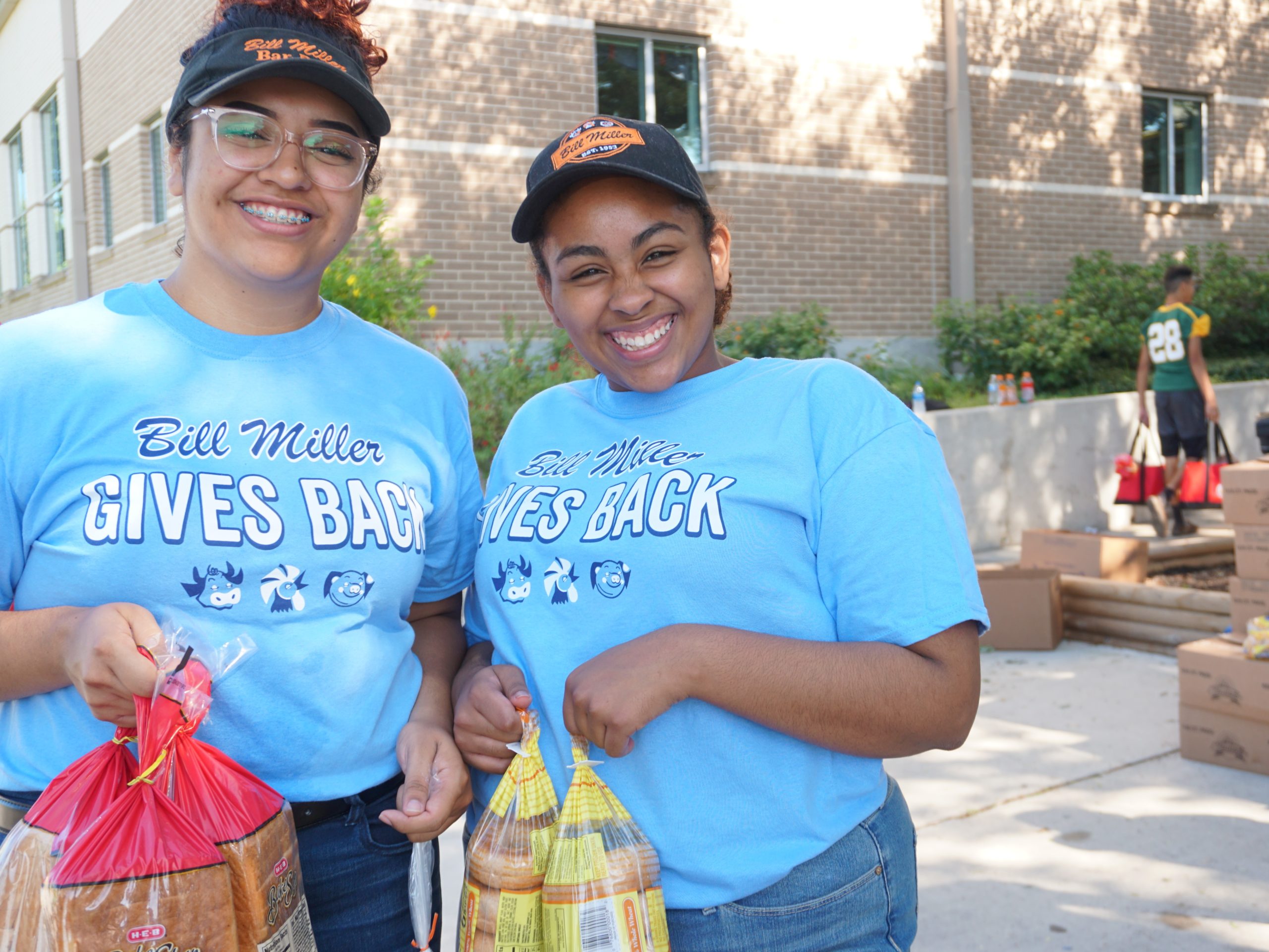 Two Bill Miller employees volunteering with San Antonio Food Bank