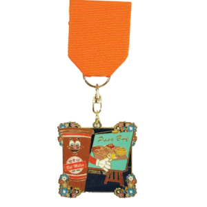 2025 Bill Miller and Laguna Madre Fiesta medal. One side represents our Bill Miller brand, showcasing Sweetie holding a paintbrush and painting a Poor Boy sandwich, fries, and pickles and onions on a teal canvas. The other side of the medal represents our Bill Miller Laguna Madre Seafood Company, showcasing two shrimp on a beach background holding paintbrushes and painting the Laguna Madre ship with a sunset. The medal has a square-shaped frame, adorned with colorful floral embellishments at each corner.