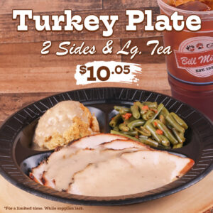 Turkey Plate 2 sides & Lg. Tea. $10.05. For a limited time. While supplies last. The image features a Turkey plate served with Giblet Gravy, Green Beans, and Cornbread Dressing served on a black plate with an iced tea beside the plate. Placed on a wooden cutting board with a brown wooden background.